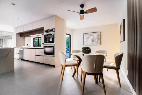 a large white kitchen with cabinets
