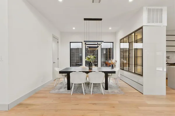 a view of a dining room with furniture and wooden floor