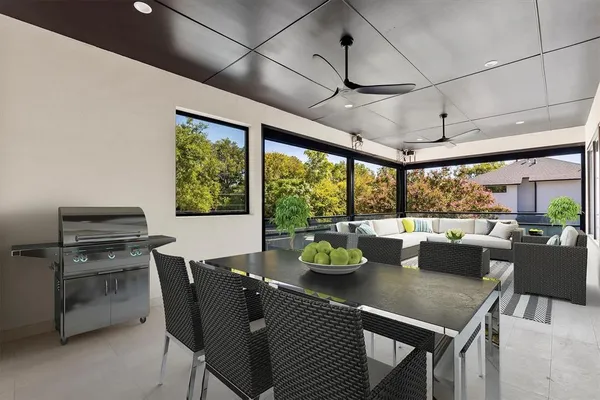 a view of a dining room with furniture large windows and wooden floor
