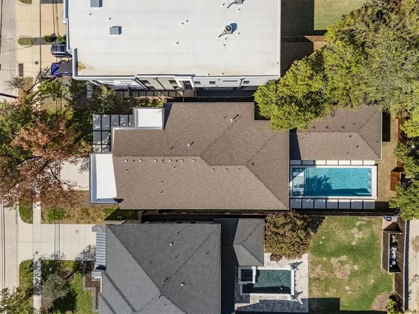an aerial view of a house with a yard