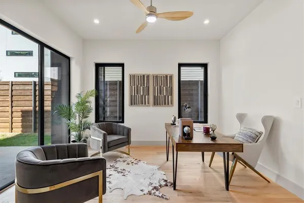 a living room with furniture and a potted plant