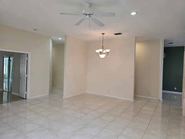 an empty room with fan and entrance