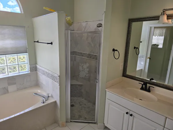 a bathroom with a tub shower and sink