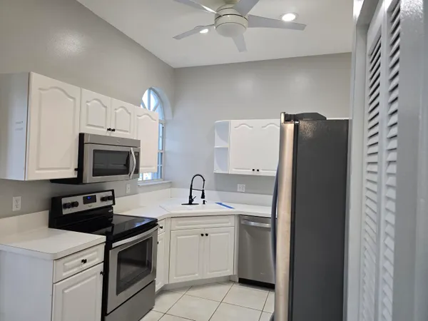 a kitchen with a sink stove and microwave