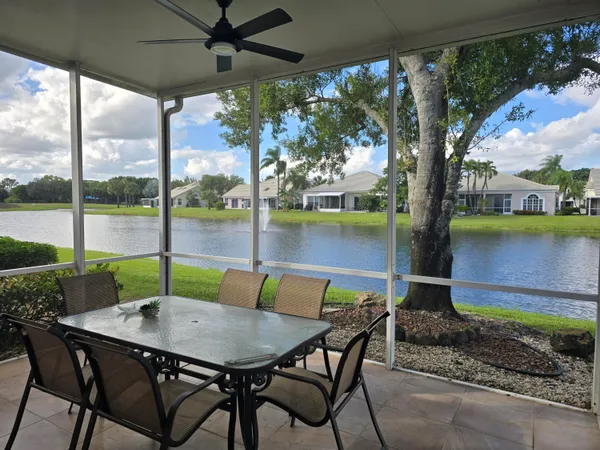 a view of an outdoor dining space with a table and chairs