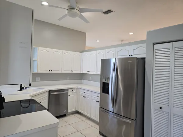 a kitchen with a sink stainless steel appliances and cabinets