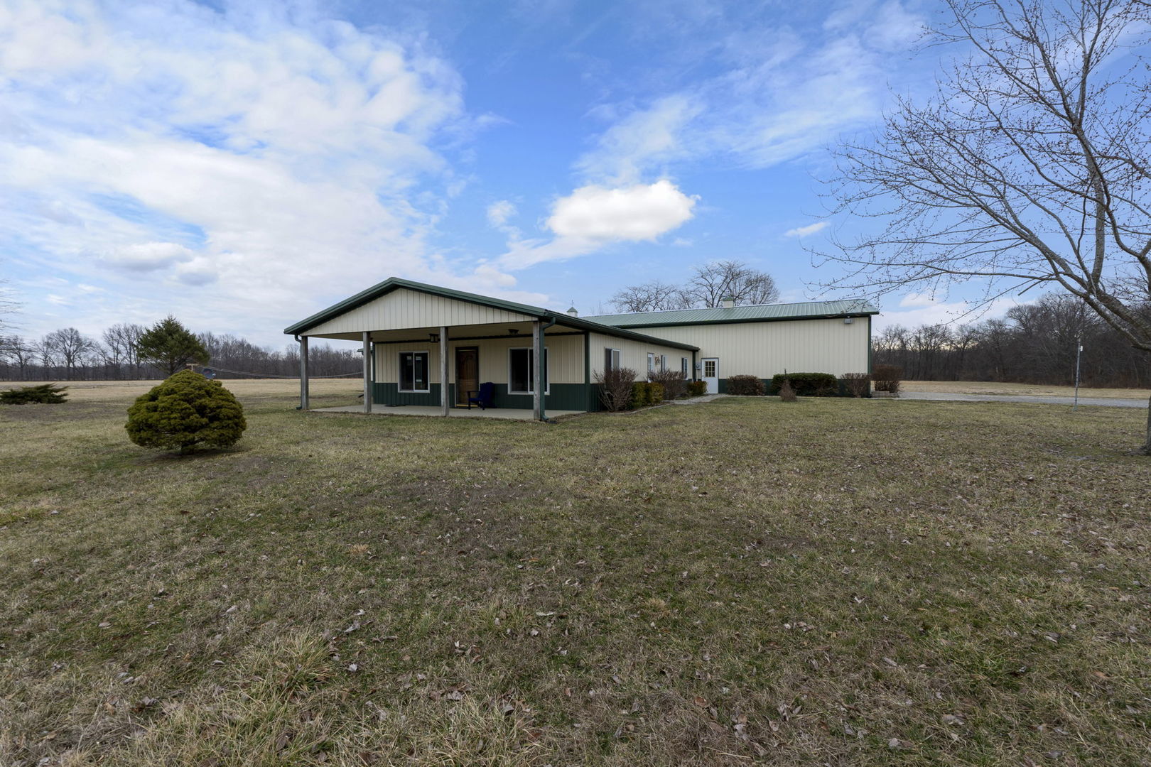 a front view of house with yard and trees around