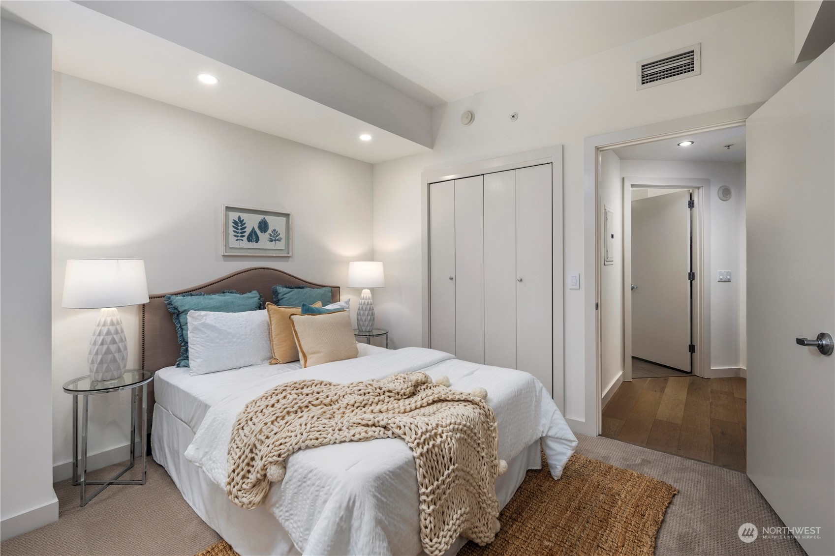 910 Lenora Street, Unit S1003 Seattle, WA 98121 - Photo 15 of 28 a bedroom with a bed and a view of bathroom