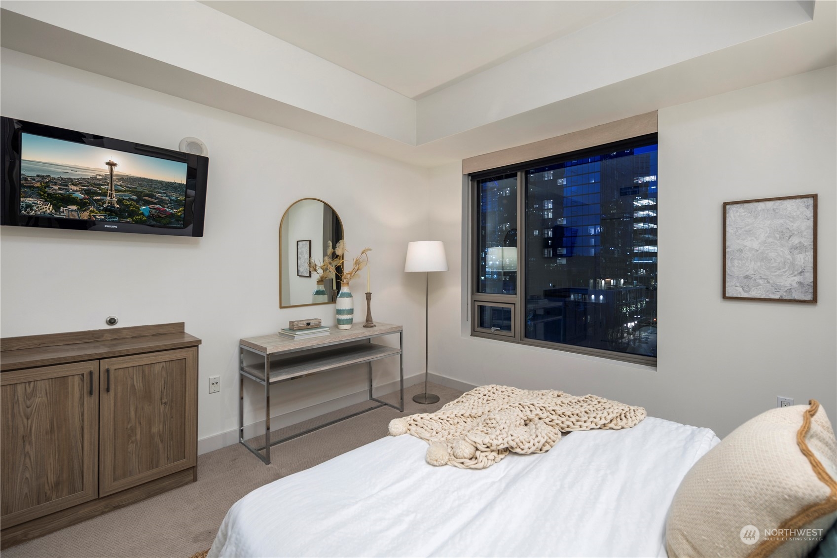 910 Lenora Street, Unit S1003 Seattle, WA 98121 - Photo 16 of 28 a bedroom with a bed and a flat screen tv