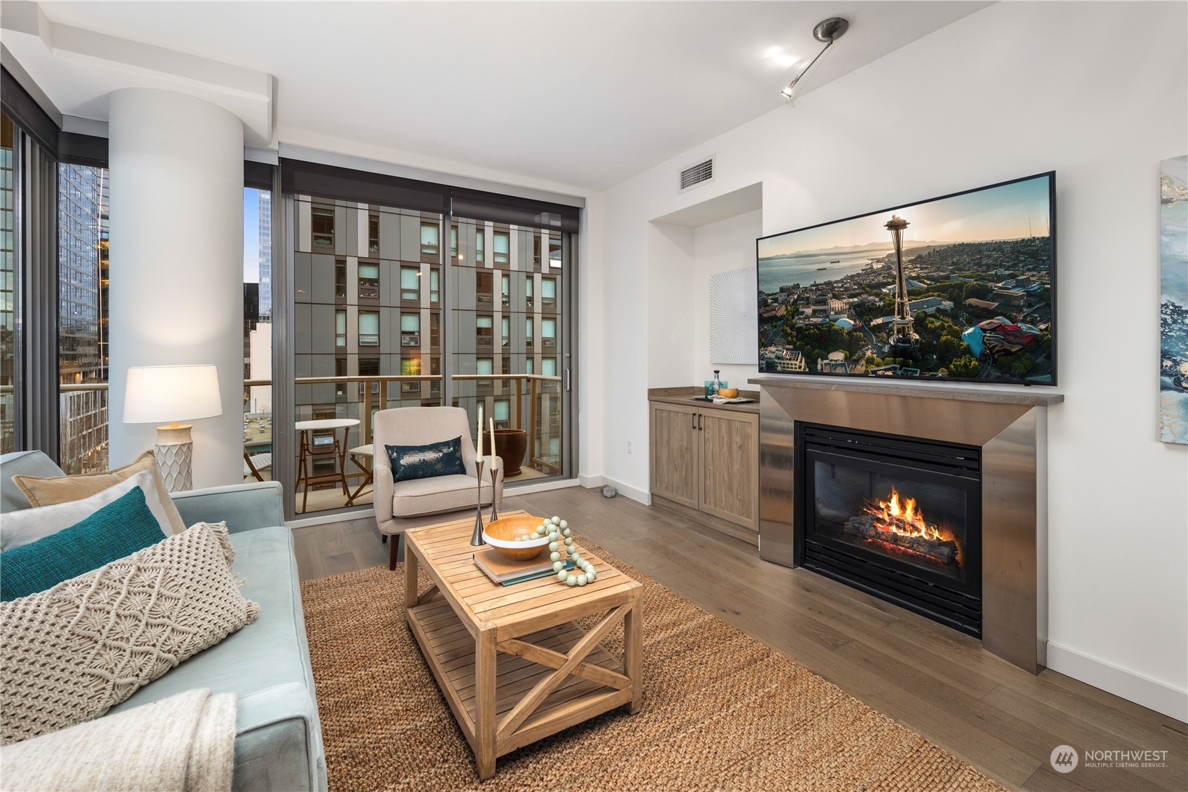 910 Lenora Street, Unit S1003 Seattle, WA 98121 - Photo 4 of 28 a living room with furniture a fireplace and a floor to ceiling window