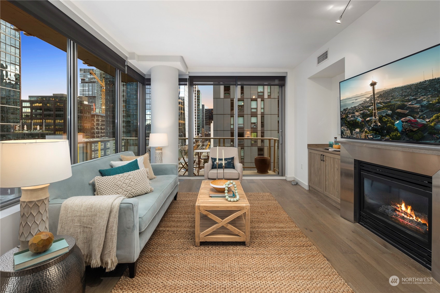 910 Lenora Street, Unit S1003 Seattle, WA 98121 - Photo 5 of 28 a living room with furniture a flat screen tv and a fireplace