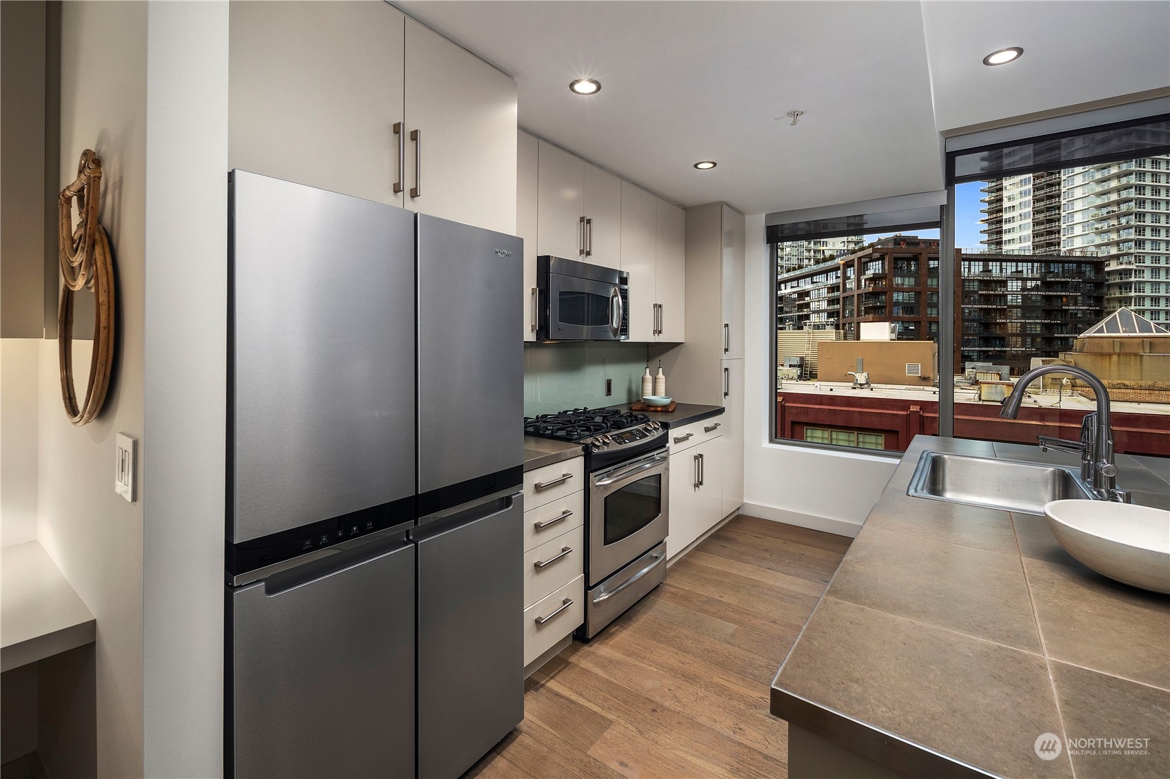 910 Lenora Street, Unit S1003 Seattle, WA 98121 - Photo 9 of 28 a kitchen with stainless steel appliances a refrigerator and a stove