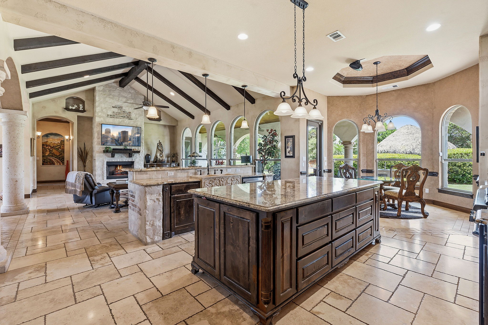 816 Brave Face Street Leander, TX 78641 - Photo 40 of 40 An open floorplan living area features vaulted ceilings, rich wood beams, and a grand fireplace.
