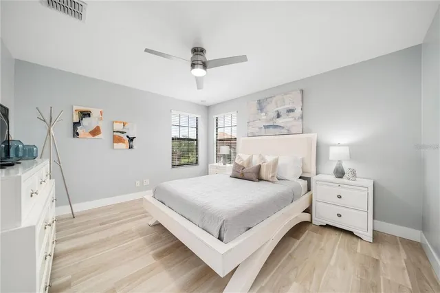 a bedroom with a large bed and a chandelier