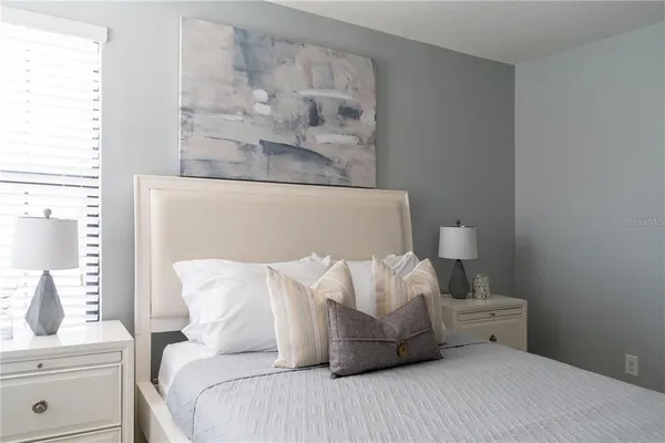 a bedroom with a bed and a night stand