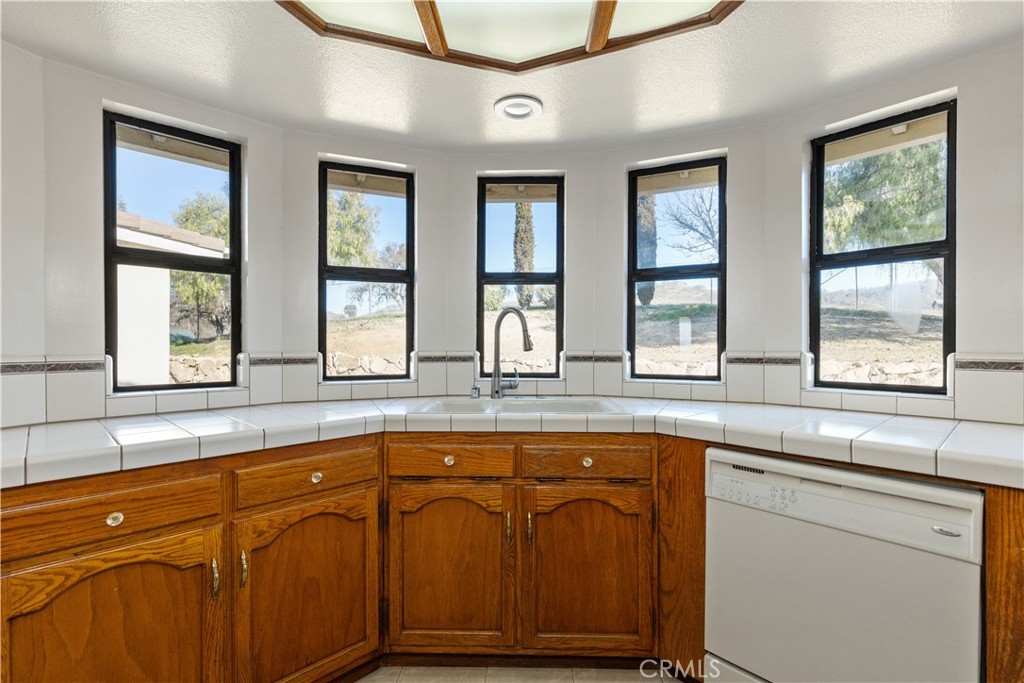 1670 Southfork Place Paso Robles, CA 93446 - Photo 30 of 61 a kitchen with stainless steel appliances granite countertop a sink a stove cabinets and a large window