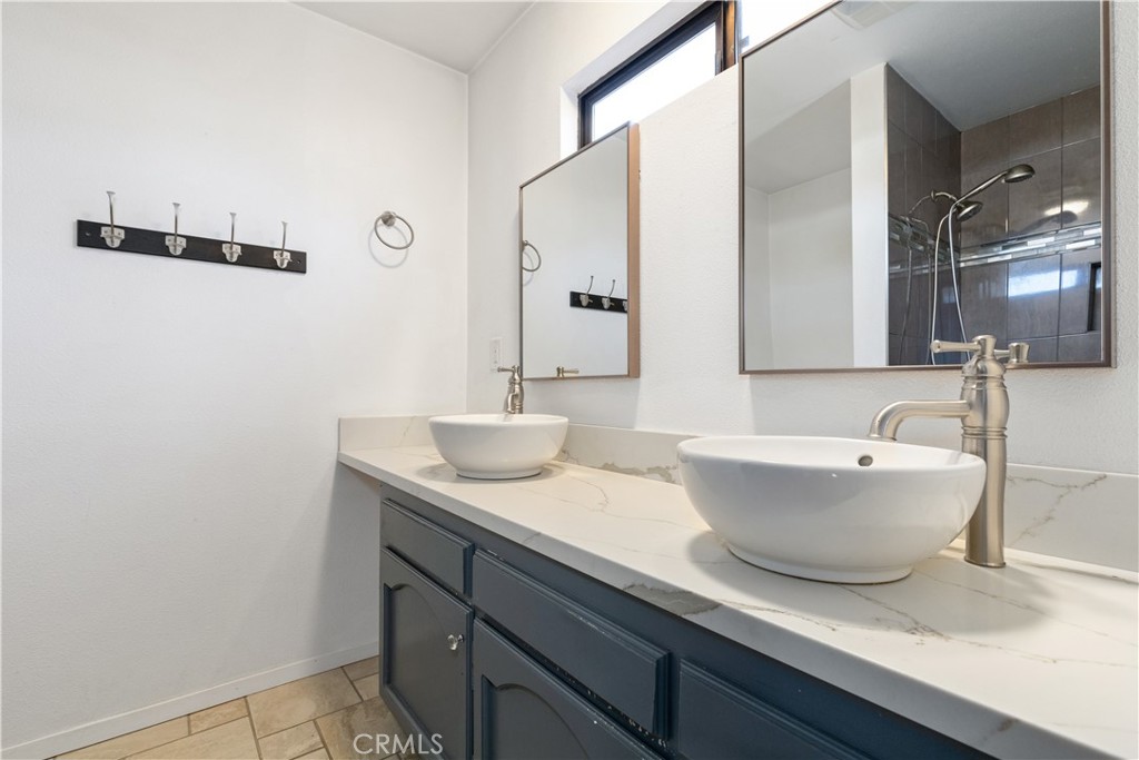 1670 Southfork Place Paso Robles, CA 93446 - Photo 49 of 61 a bathroom with a granite countertop sink and a mirror