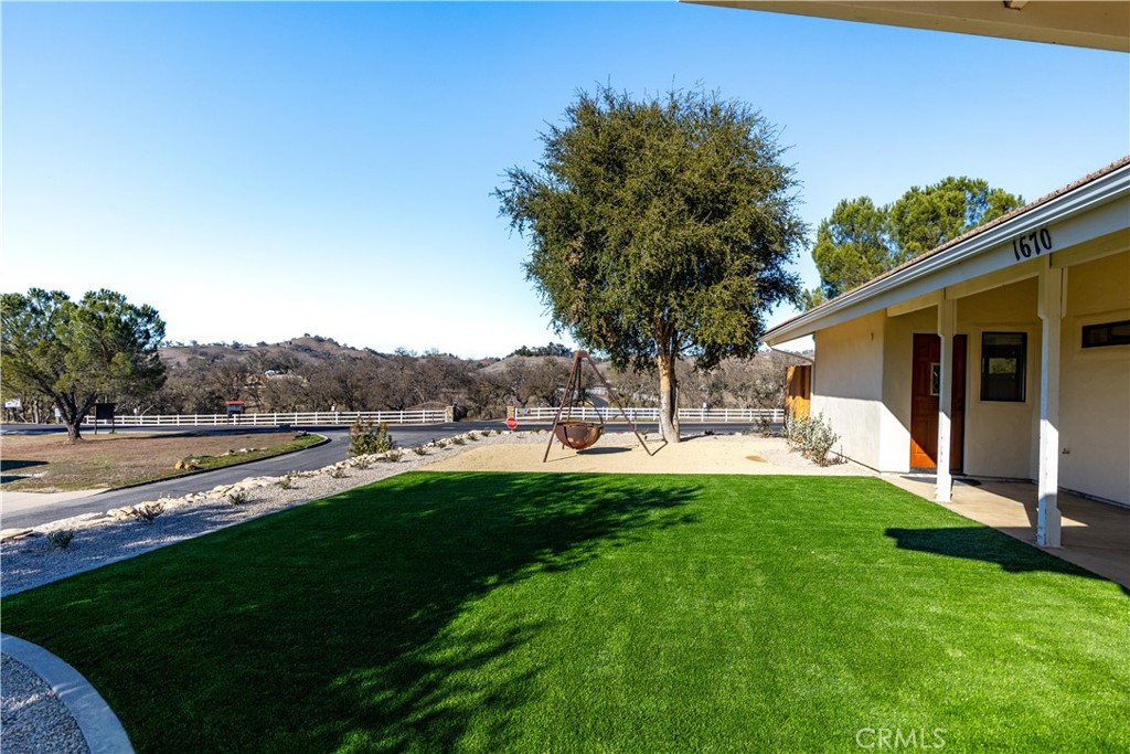 1670 Southfork Place Paso Robles, CA 93446 - Photo 8 of 61 a view of a patio with table and chairs under an umbrella