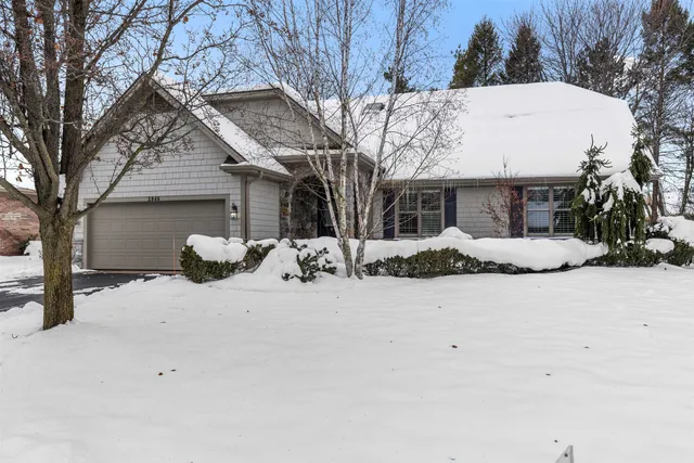 a view of a house with a snow in the yard
