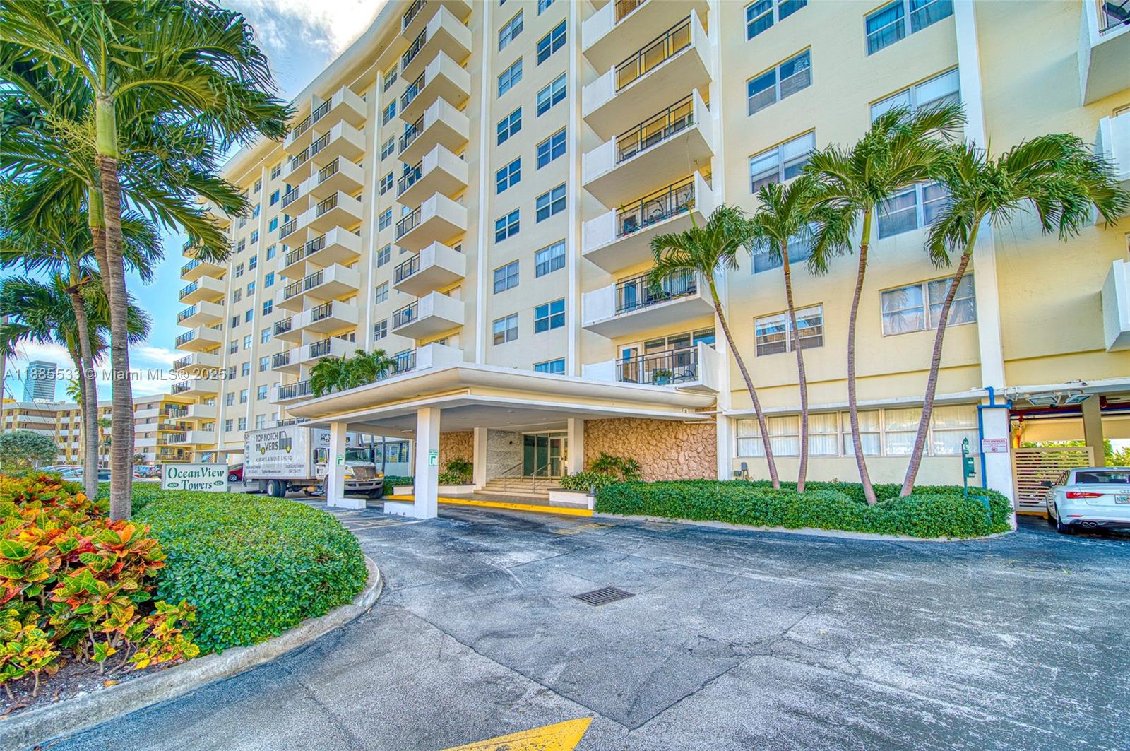 401 Golden Isles Drive, Unit 908 Hallandale Beach, FL 33009 - Photo 3 of 23 a view of a building with a yard and plants