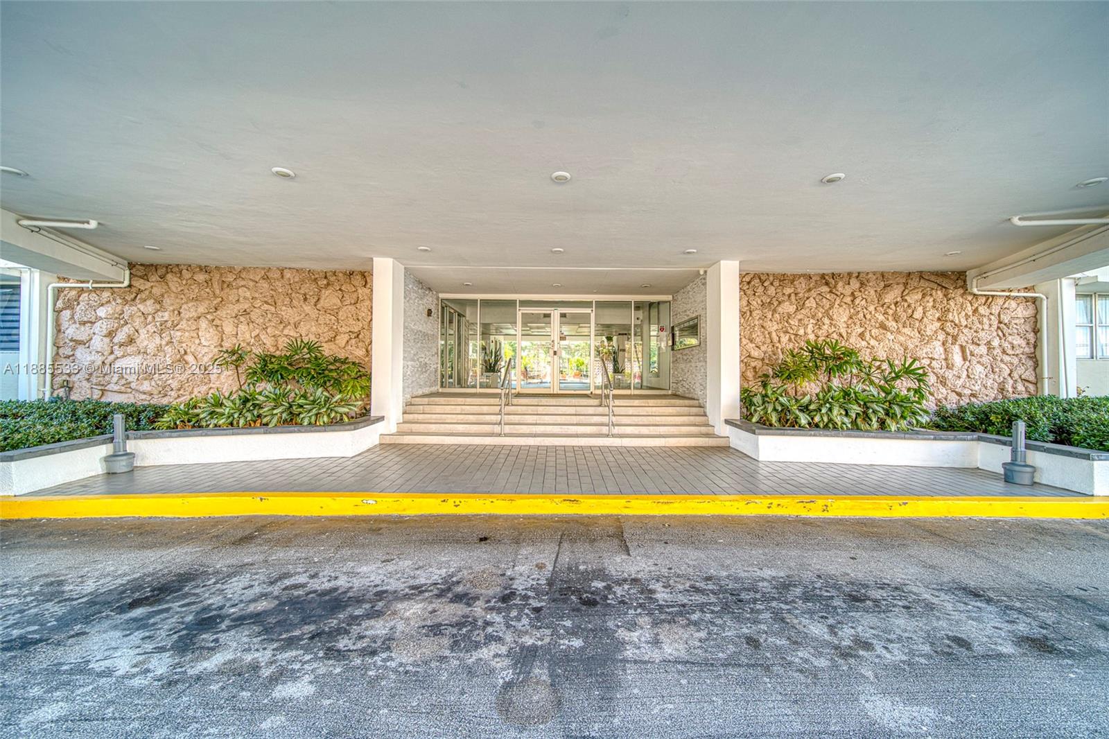 401 Golden Isles Drive, Unit 908 Hallandale Beach, FL 33009 - Photo 4 of 23 a view of a swimming pool and a yard
