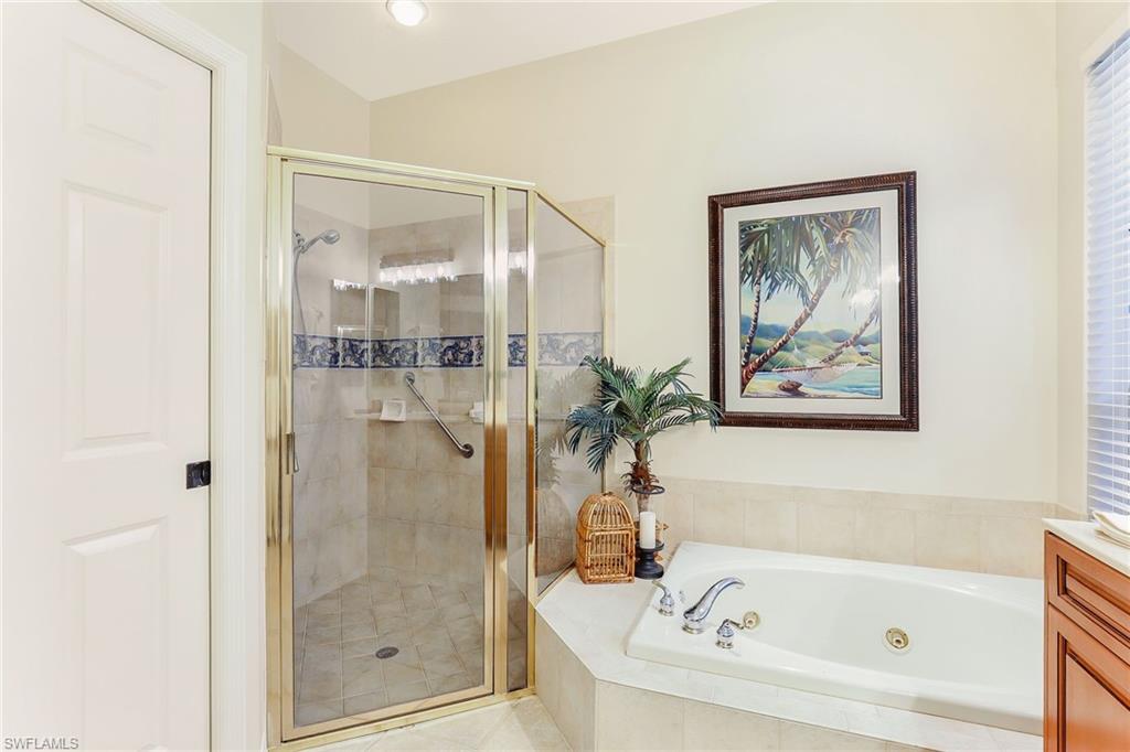 2885 Lone Pine Lane Naples, FL 34119 - Photo 15 of 29 a white bath tub sitting next to a shower