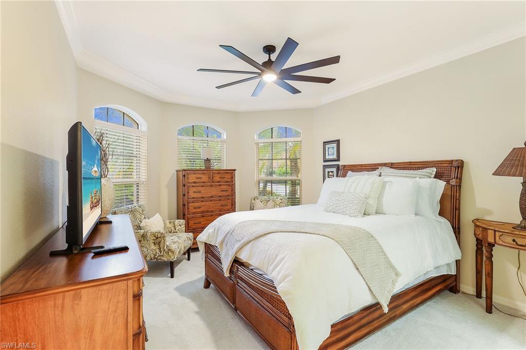 2885 Lone Pine Lane Naples, FL 34119 - Photo 16 of 29 a bedroom with a bed flat screen tv and a large window