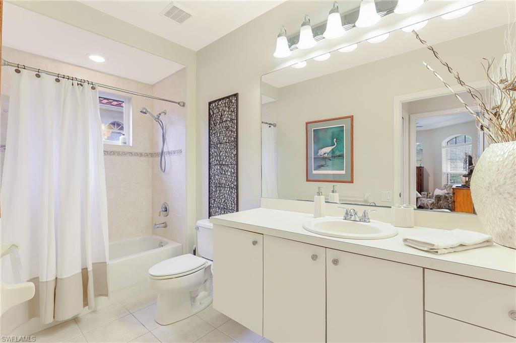 2885 Lone Pine Lane Naples, FL 34119 - Photo 18 of 29 a bathroom with a double vanity sink mirror and toilet
