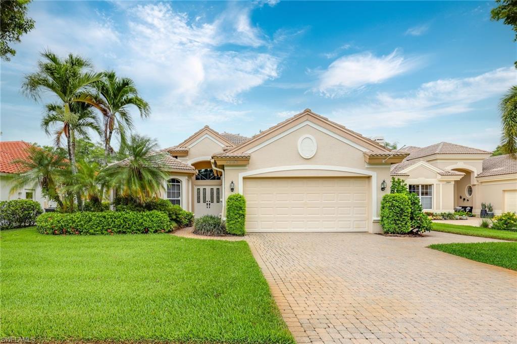 2885 Lone Pine Lane Naples, FL 34119 - Photo 23 of 29 a front view of a house with a yard and garage