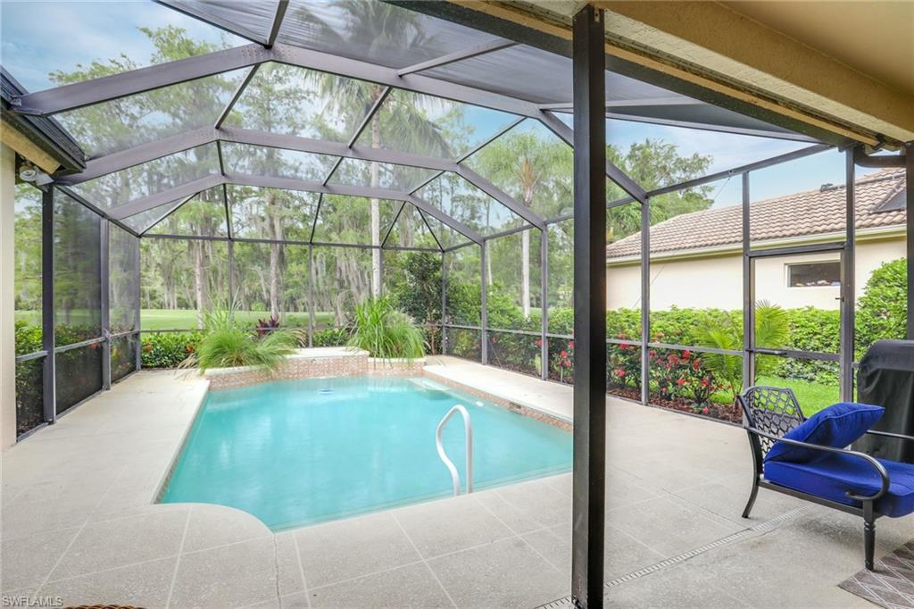 2885 Lone Pine Lane Naples, FL 34119 - Photo 24 of 29 a swimming pool with outdoor seating and yard