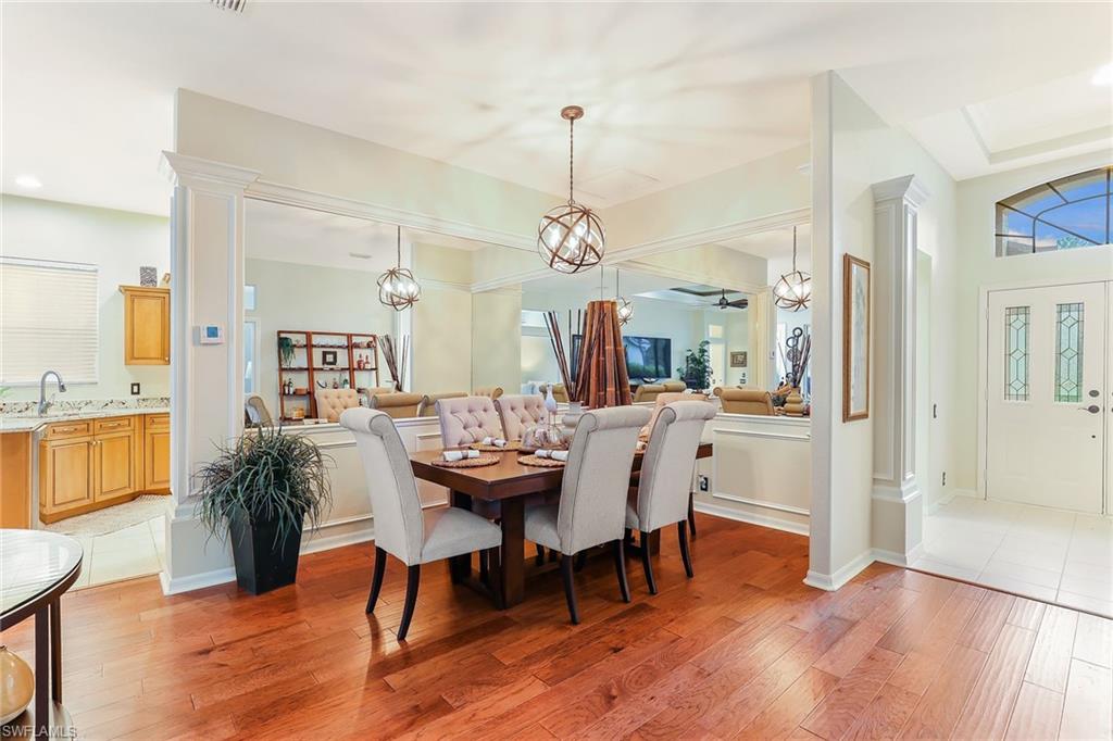 2885 Lone Pine Lane Naples, FL 34119 - Photo 8 of 29 a view of a a dining room with furniture window and wooden floor
