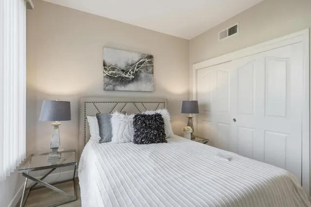 a bedroom with a bed and chair