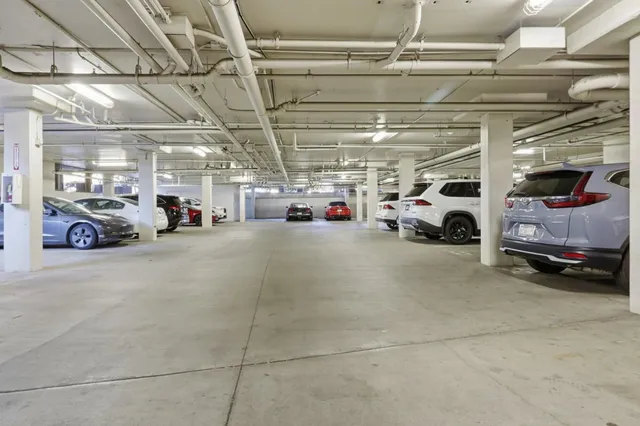 a view of parking garage with cars