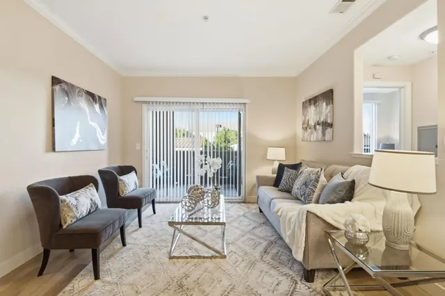 a living room with furniture and a large window