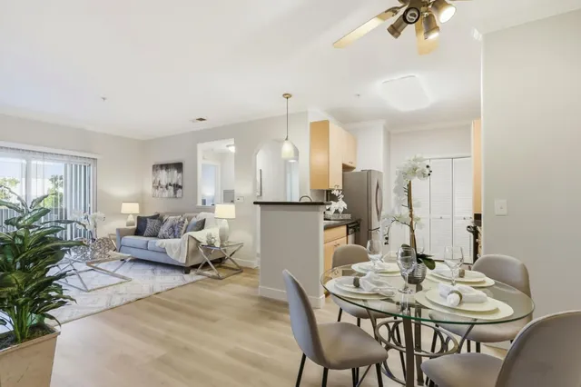 a living room with furniture and a chandelier