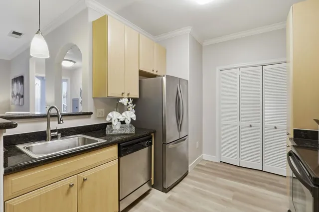 a kitchen with a sink and refrigerator