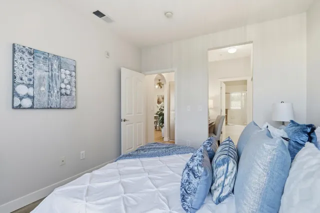 a bedroom with a bed and a mirror