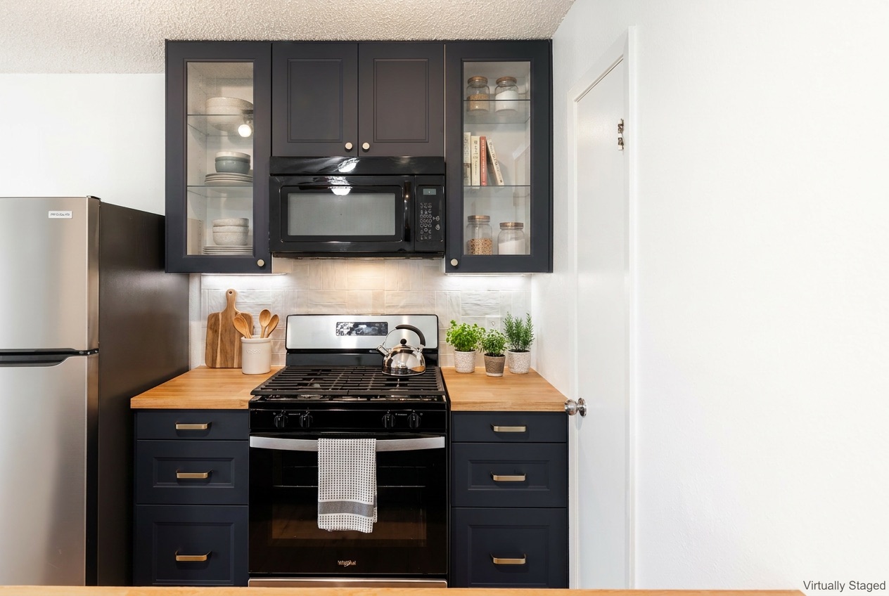 706 Ramble Lane, Unit B Austin, TX 78745 - Photo 5 of 12 a kitchen with stainless steel appliances granite countertop a stove and a refrigerator