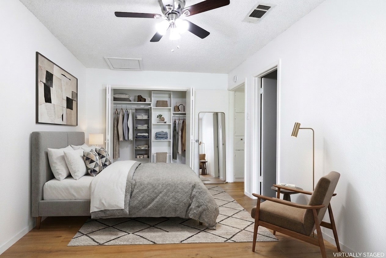 706 Ramble Lane, Unit B Austin, TX 78745 - Photo 8 of 12 a bedroom with a large bed and a chair