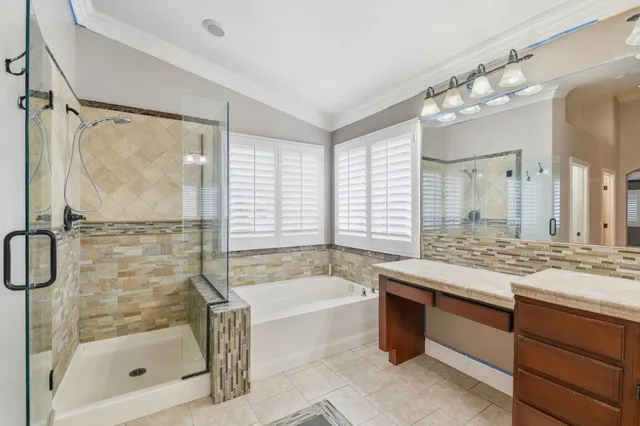 a spacious bathroom with a granite countertop sink mirror and cabinets