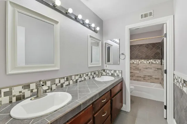 a utility room with sink dryer and washer