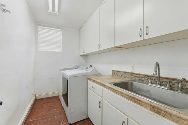 a view of a house with a yard and sitting area