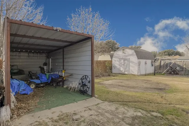 a view of a backyard with table and chairs and potted plants