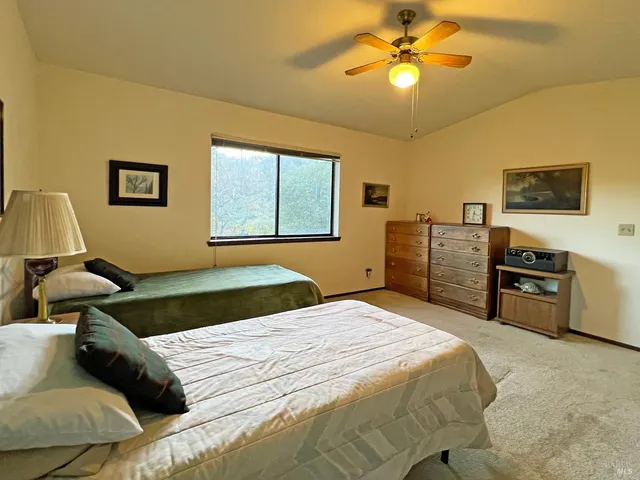 a bedroom with a bed and ceiling fan