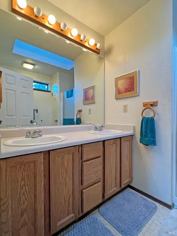 a bathroom with a double vanity sink and a mirror