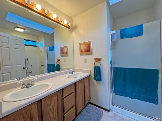 a bathroom with a double vanity sink and mirror