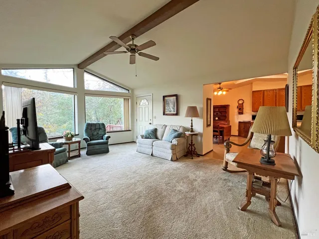 a bedroom with furniture and a large window
