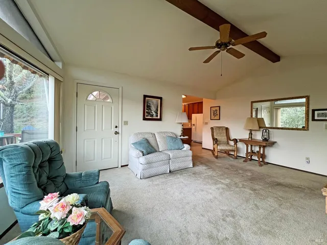 a living room with furniture and a floor to ceiling window
