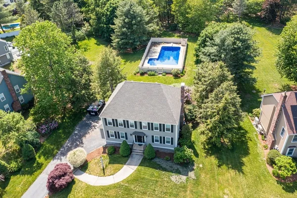 an aerial view of a house with garden space and street view