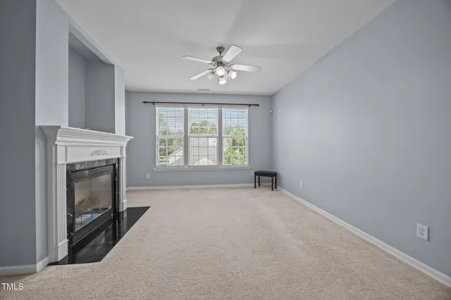 an aerial view of a house with a yard and balcony